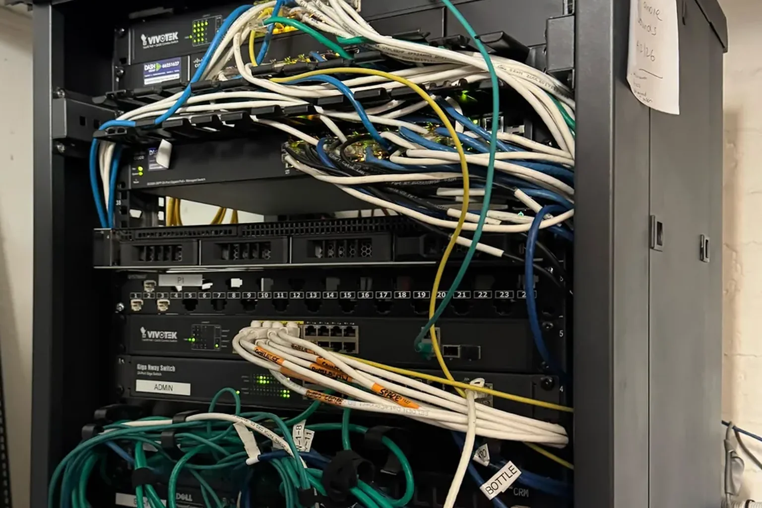 A venue comms rack crowded with tangled patch cables